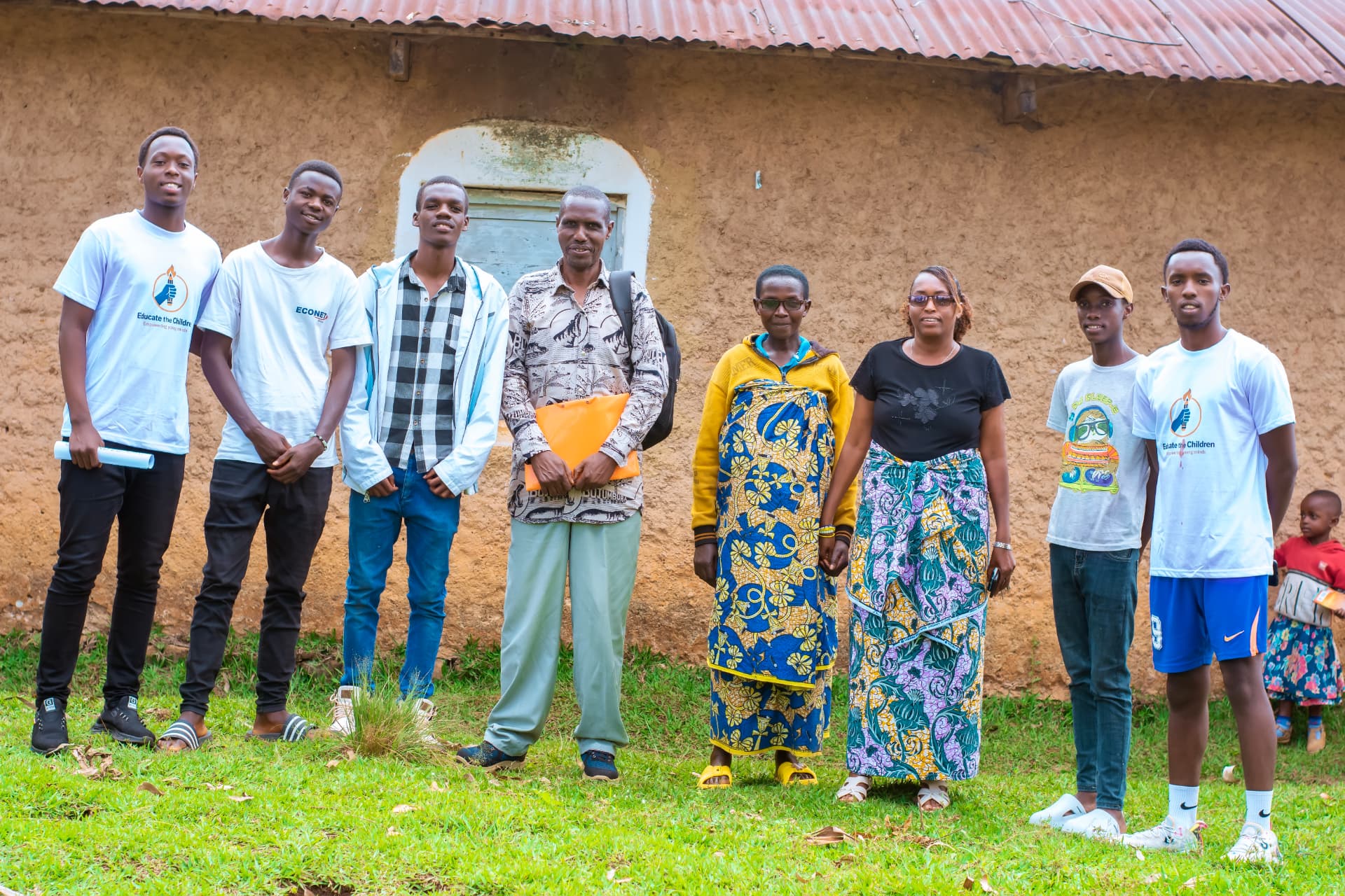 Volunteers with parents, guardians and community leaders after a visit in Burundi.